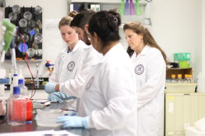 Dr. Bertke working with students in a lab setting