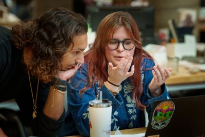 Jaylee Lederhouse (at right) talks with a man (at left) in Burchard Hall.